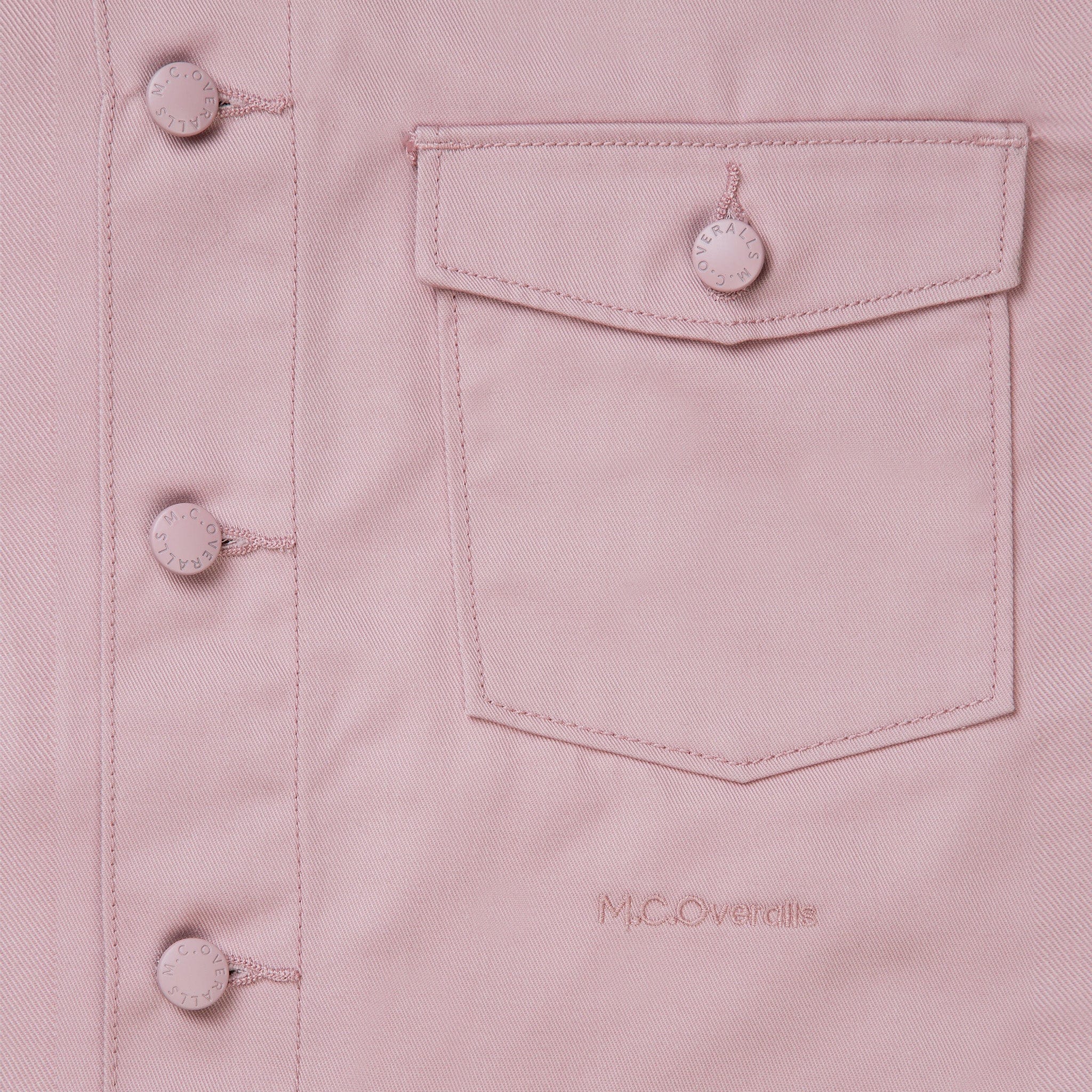 Logo of M.C.Overalls Placed Below the Pocket of Premium Pink Work Jacket.