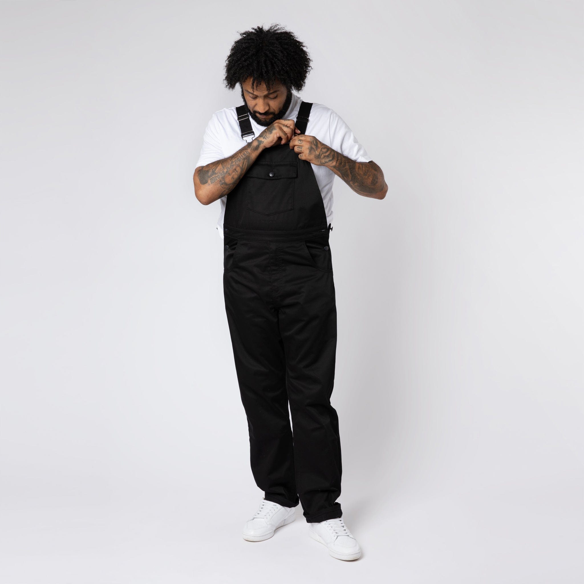 A Man Wearing Polycotton Black Dungarees/Bib in M.C.O&#39;s Soho Store.