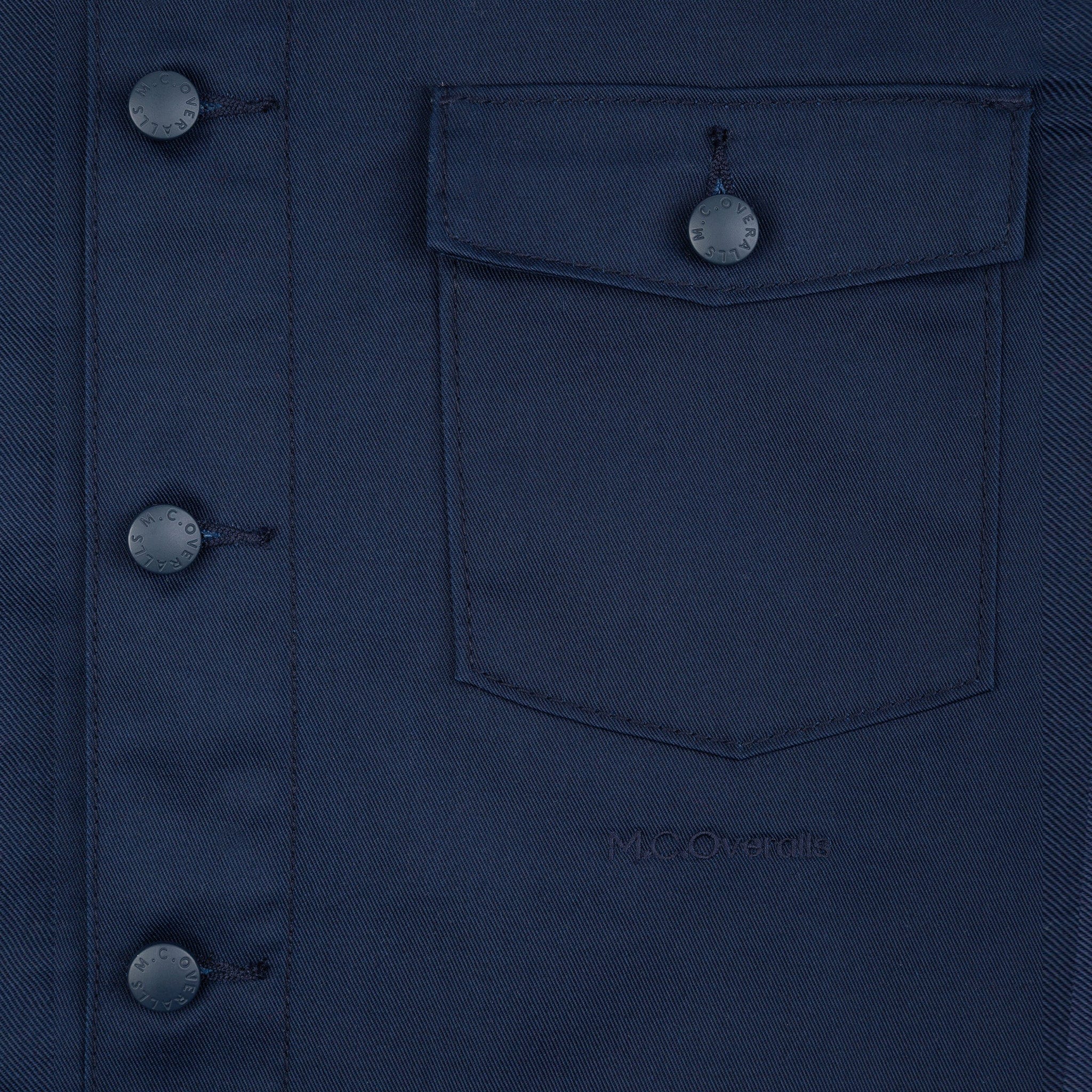 M.C.O&#39;s Logo Placed below the Pocket of Polycotton Navy Work Jacket.